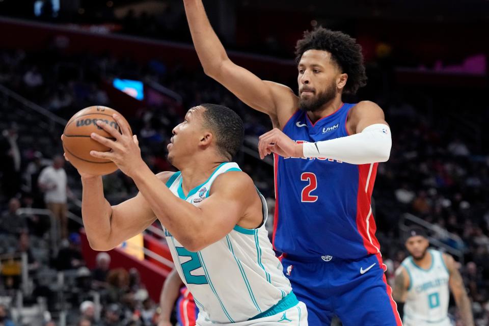 Charlotte Hornets forward Grant Williams (2) is defended by Detroit Pistons guard Cade Cunningham (2) during the first half at Little Caesars Arena in Detroit on Monday, March 11, 2024.