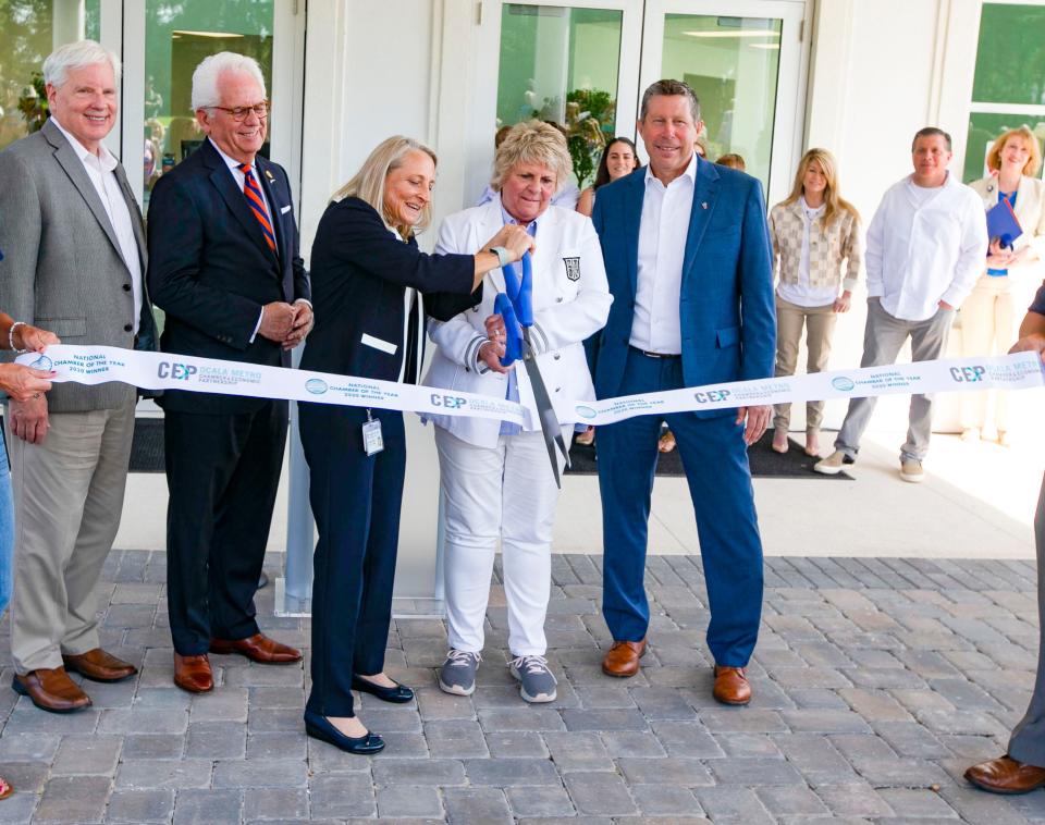 Dr. Dana Zimmel, left, and WEC owner Mary Roberts cut the ribbon as the UF Veterinary Hospital at WEC opened Wednesday.