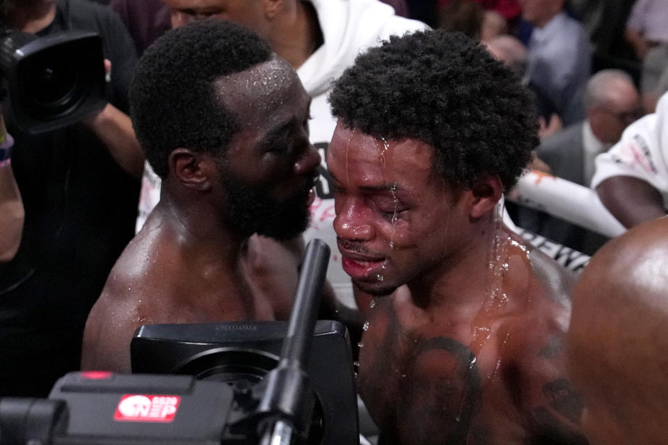 Terence Crawford, left, talks with Errol Spence Jr. fight after Crawford won their undisputed welterweight championship boxing match, Saturday, July 29, 2023, in Las Vegas. (AP Photo/John Locher)