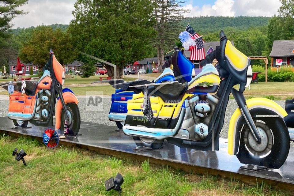 Motorcycle likenesses, part of a memorial to honor members of the Jarheads Motorcycle Club killed in a nearby crash, are visible July 13, 2022, on the roadside in Randolph, N.H.