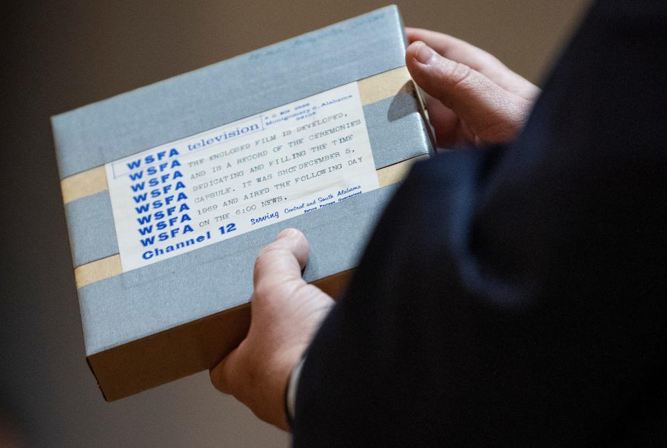 Film from WSFA is pulled from a time capsule that was sealed into City Hall during Montgomery's 150th anniversary in 1969 with instructions not to open it until the city's 200th anniversary, in Montgomery, Ala., on Dec. 3, 2019.