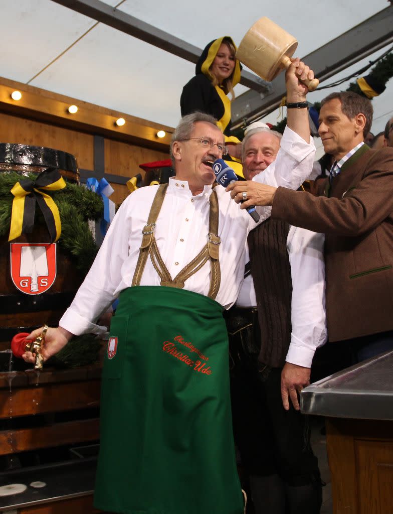 Munich mayor Christian Ude taps the first barrel of beer with the traditional 'O'zapft is!' (It's tapped!) to start the Oktoberfest 2012 beer festival at Theresienwieseat on September 22, 2012 in Munich, Germany.