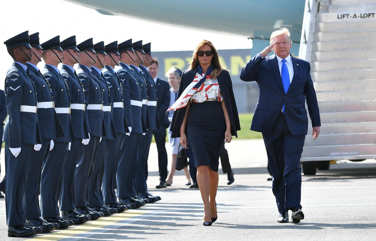 US President Donald Trump (R) and US First Lady Melania Trump (L) walk on the tarmac after disembarking Air Force One at Stansted Airport, north of London on June 3, 2018, as they begin a three-day State Visit to the UK. - Britain rolled out the red carpet for US President Donald Trump on June 3 as he arrived in Britain for a state visit already overshadowed by his outspoken remarks on Brexit. (Photo by MANDEL NGAN / AFP)        (Photo credit should read MANDEL NGAN/AFP/Getty Images)