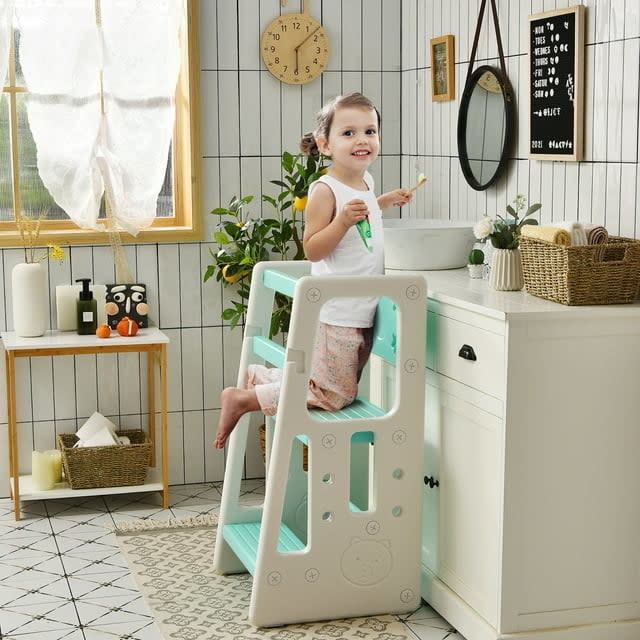 kid kneeling on mostly white step stool