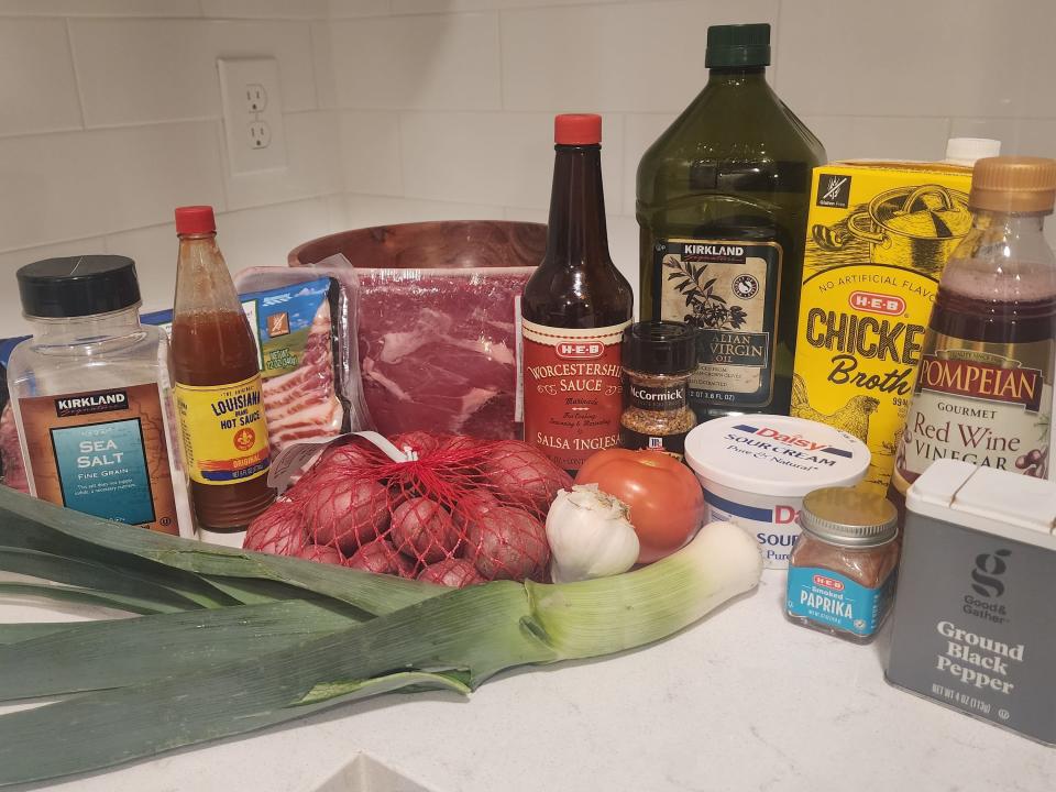Ingredients for steak including meat, leeks, potatoes, and garlic