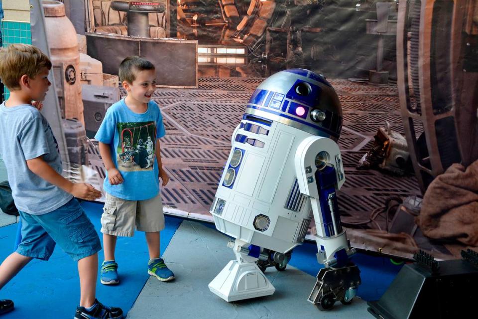 May The Fourth Star Wars Day brought out hundreds to Tenth Street Plaza May 4, 2018, in Modesto, Calif. The free public event included Star Wars cosplayers, live music and a performance by the Beyer High band. Pictured are Ezekiel Lecher and Caleb Clements of Modesto checking out R2-D2. Marijke Rowland/mrowland@modbee.com