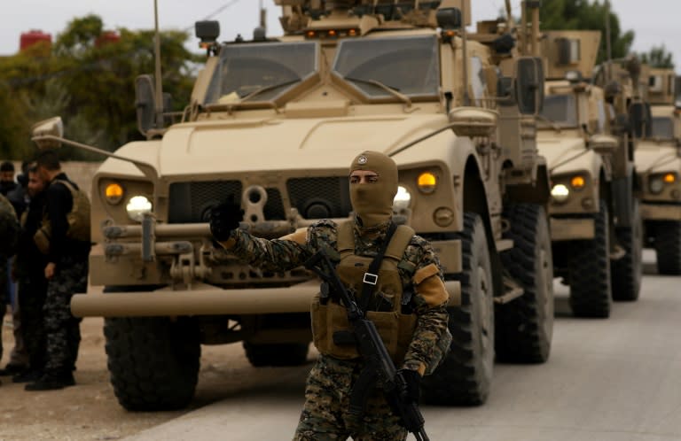 US soldiers and fighters of the Syrian Democratic Forces carry out a joint patrol of the Kurdish town of Al-Darbasiyah on the Turkish border on November 4, 2018, in a confidence-building move adopted after Turkish threats on the Kurdish heartland