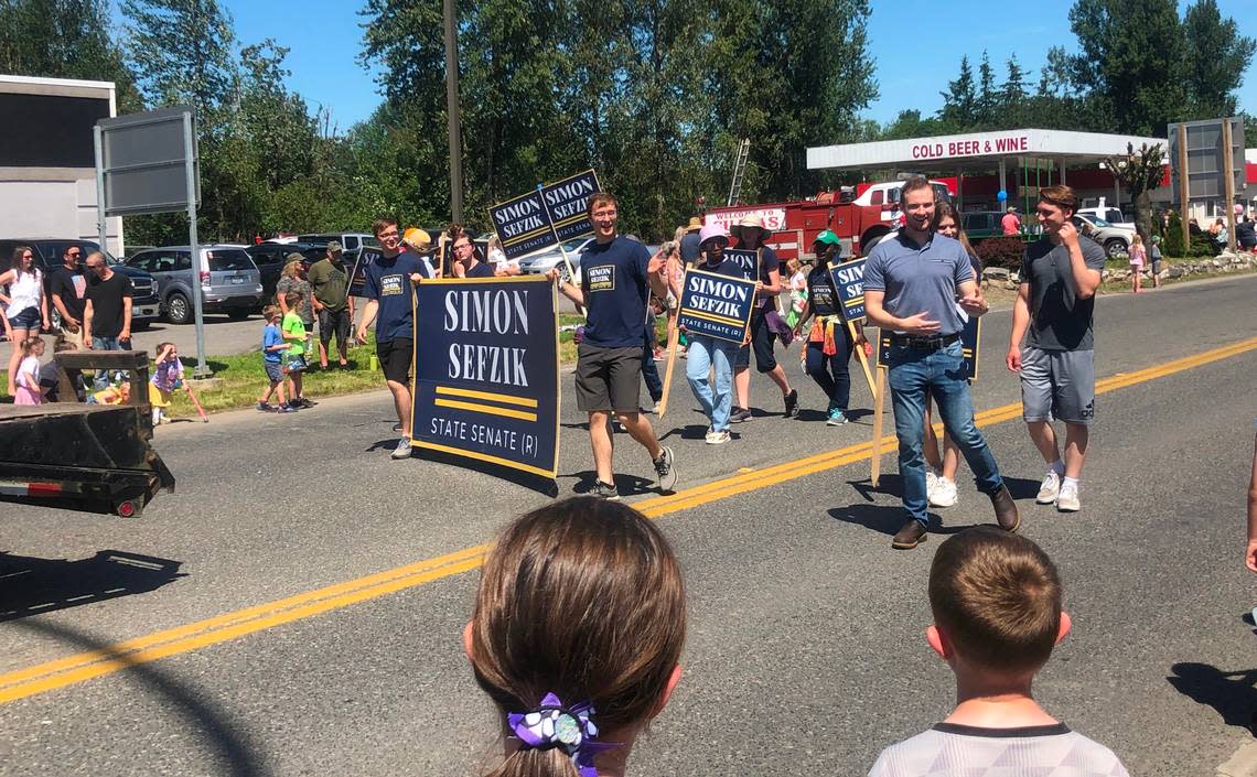 State Sen. Simon Sefzik marches with his supporters in the Sumas Community Days Parade Saturday, June 25, in Sumas. Sefzik, R-Ferndale, a former White House intern and recent graduate of Patrick Henry College, was appointed by the Whatcom County Council in January to serve the remainder of late Republican Sen. Doug Ericksen’s term and is running his first campaign to retain the 42nd District state Senate seat.