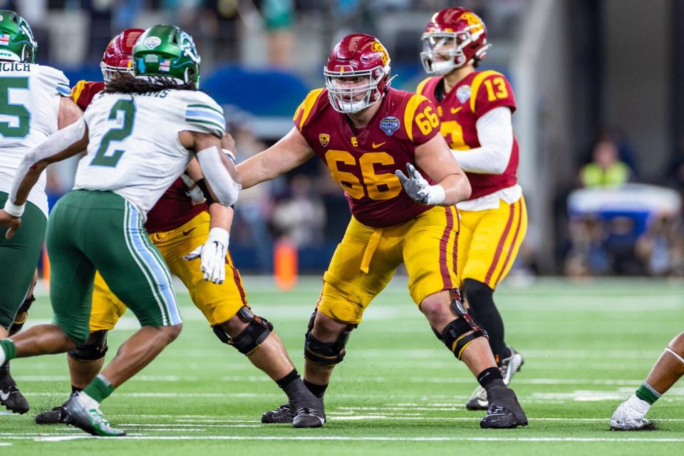 USC offensive lineman Gino Quinones blocks quarterback Caleb Williams in the Cotton Bowl.