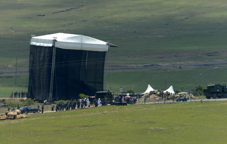 The coffin of South African former president Nelson Mandela is carried for burial during his funeral in Qunu on December 15, 2013