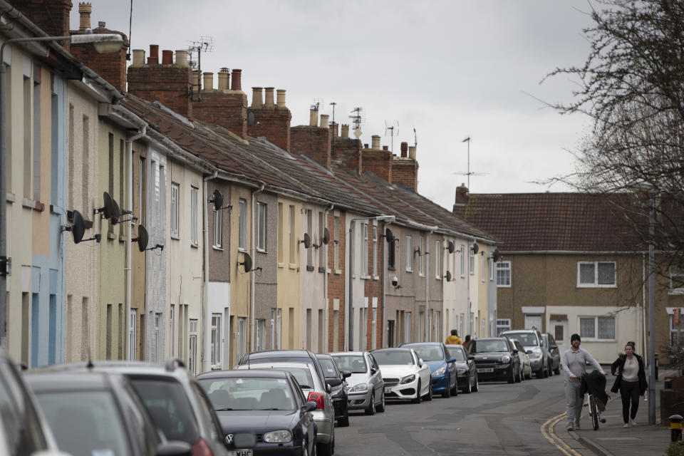 SWINDON, ENGLAND - FEBRUARY 20: A couple walk past a row of terraced housing near the town centre on February 20, 2019 in Swindon, England. The car manufacturer Honda announced on Tuesday it is to shut down the Swindon plant in 2022, putting 3,500 jobs at risk. The factory is Honda's only EU plant and has produced the Honda's 'Civic' model for over 24 years, with 150,000 of the cars rolling off the line annually. The manufacturer is a major employer in the town of around 220,000 and sits on the M4 corridor between London to the East and Bristol to the West. In 1986 one of the towns last major employers GWR (Great Western Railway) closed it's doors after a 140 year history of Railway locomotive manufacture putting around 1,500 people out of work. (Photo by Dan Kitwood/Getty Images)