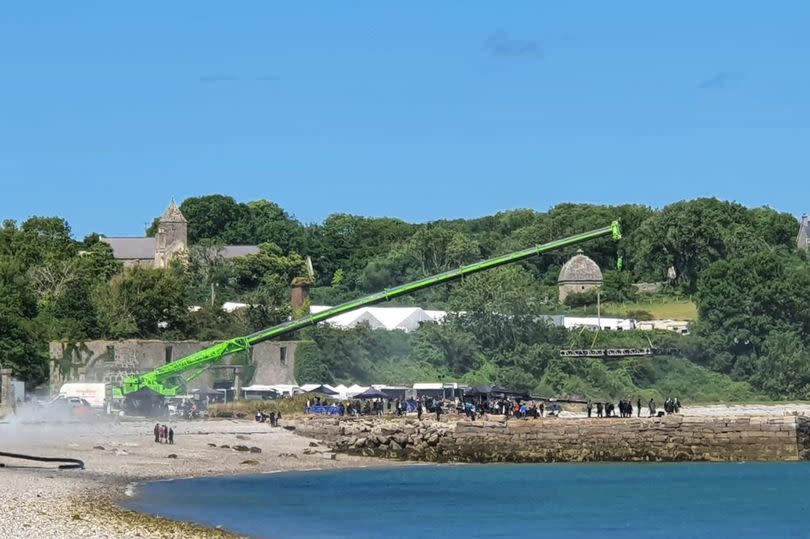 Filming on the old stone pier below Penmon Priory