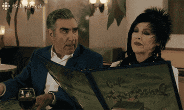 Johnny and Moira out to eat in Schitt's Creek, Moira taking her time and Johnny saying "well, I'm ready to order."