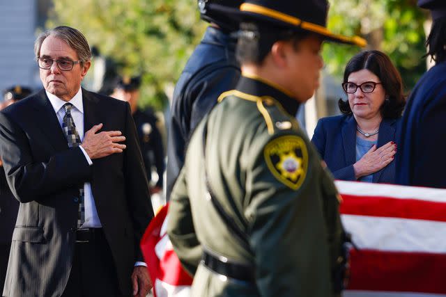 <p>Jessica Christian-Pool/Getty </p> Dianne Feinstein's son-in-law Rick Mariano and daughter Katherine Feinstein greet their mother's body as it arrives at City Hall