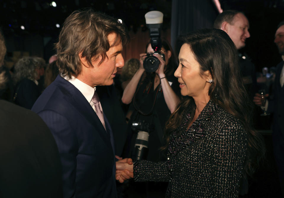 Tom Cruise, left, and Michelle Yeoh attend the 95th Academy Awards Nominees Luncheon on Monday, Feb. 13, 2023, at the Beverly Hilton Hotel in Beverly Hills, Calif. (Photo by Willy Sanjuan/Invision/AP)