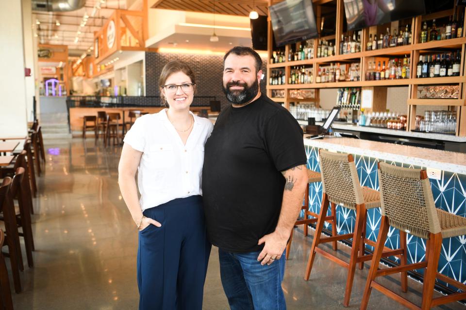 Ashley and Paul Moody pose for a photo at Marble City Market on Aug. 2, shortly after it was announced the couple behind SmashCity Knoxville would be taking over management responsibilities from Hospitality HQ at Knoxville's first food hall. The Moodys later joined "The Scruffy Stuff" podcast to discuss how operations would be different under their leadership as the food hall attempts to bounce back from a tumultuous first year in business.