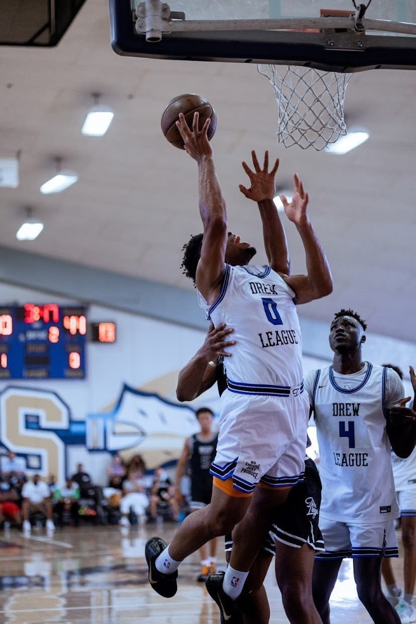 E.J. Anosike hangs in the air while shooting a layup.