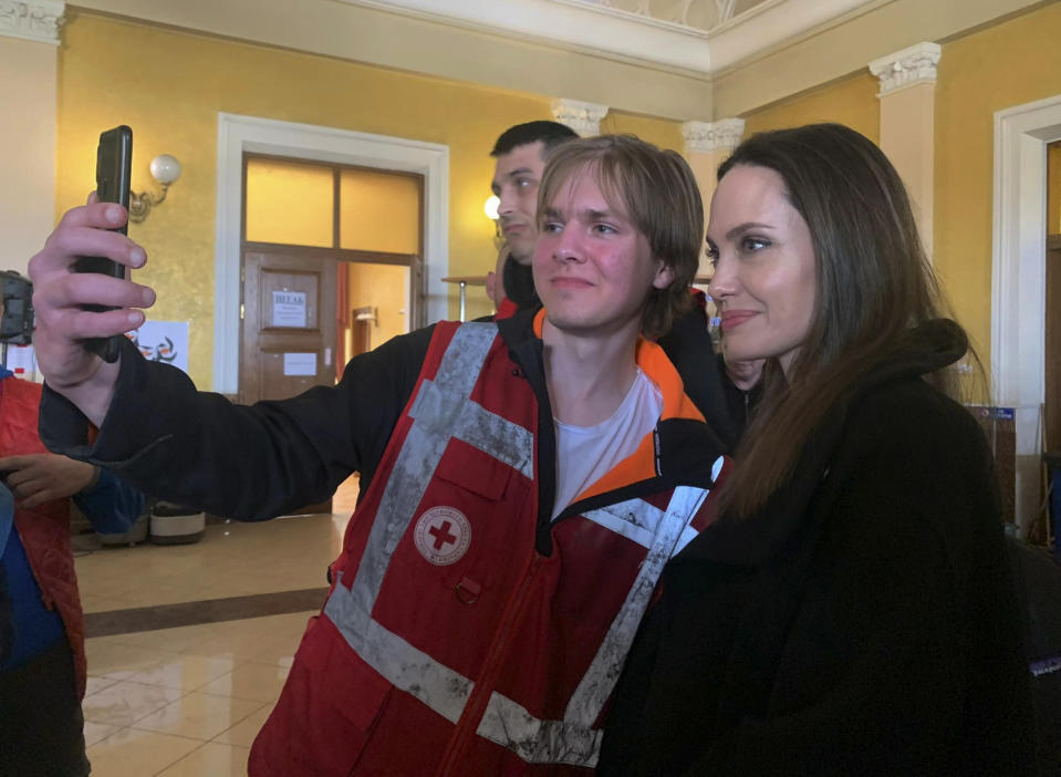 Angelina Jolie, Hollywood movie star and UNHCR goodwill ambassador, poses for photo with her fans in Lviv, Ukraine, Saturday, April 30, 2022. Ms Jolie was in Ukraine to meet the children affected by the war and visited hospitals and NGOs helping the injured and displaced.(AP Photo/VEduard Tomilchenko)