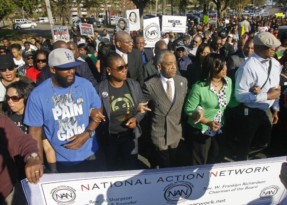 From left, participants including Lucia McBath, mother of Jordan Davis, Tracy Martin and Sybrina Fulton, parents of Trayvon Martin, Rev. Al Sharpton, president of National Action Network, and Phyllis Giles, mother of Michael Giles, march to the Florida Capitol Monday, March 10, 2014, in Tallahassee, Fla. Participants were rallying against the state's "Stand Your Ground" laws. (AP Photo/Phil Sears)