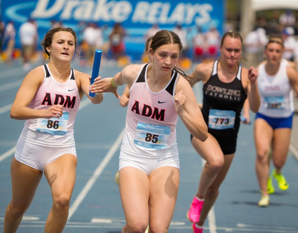 Jada Grove of ADM hands the baton to Josi Dufoe during the girls 4x200 meter relay at the Drake Relays, Friday, April 28, 2023. 