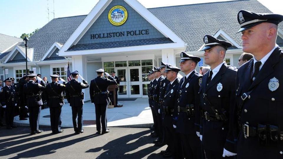 Holliston police officers report for roll call outside the station in 2020. Chief Mike Stone said the department has been able to handle staffing issues caused by COVID-19 outbreaks with overtime, rather than redeploying specialty officers.