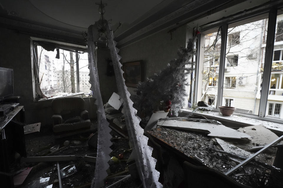 A new year tree is seen inside a residential house damaged by a Russian missile strike in Kharkiv, Ukraine, Tuesday, Jan. 2, 2024. (AP Photo/Andrii Marienko)