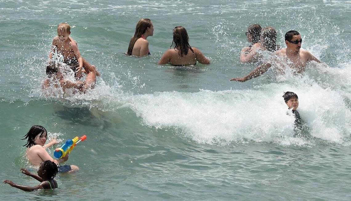 Swimmers crowd the waters at Wrightsville Beach, near Johnny Mercer pier. Chuck Liddy/cliddy@newsobserver.com