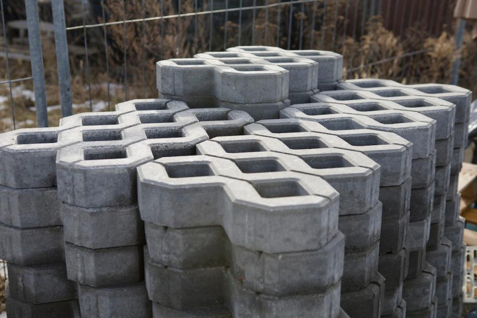 A stack of permeable concrete grass driveway pavers waiting to be installed