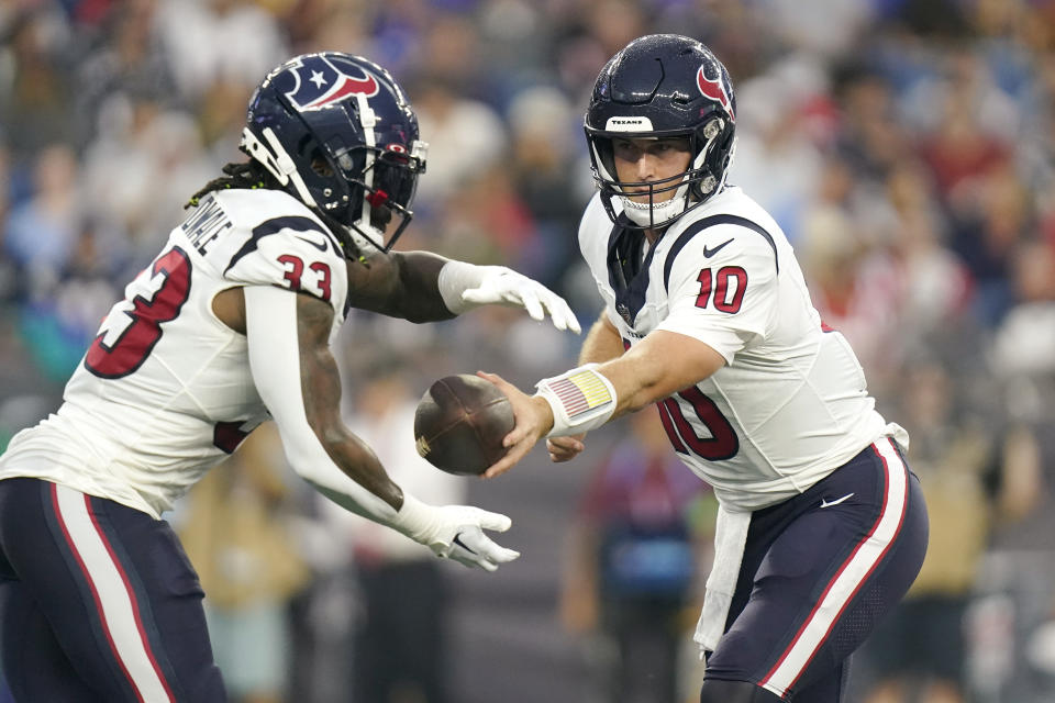 Houston Texans quarterback Davis Mills (10) hands off to running back Dare Ogunbowale (33) during the first half of the team's NFL preseason football game against the New England Patriots, Thursday, Aug. 10, 2023, in Foxborough, Mass. (AP Photo/Steven Senne)