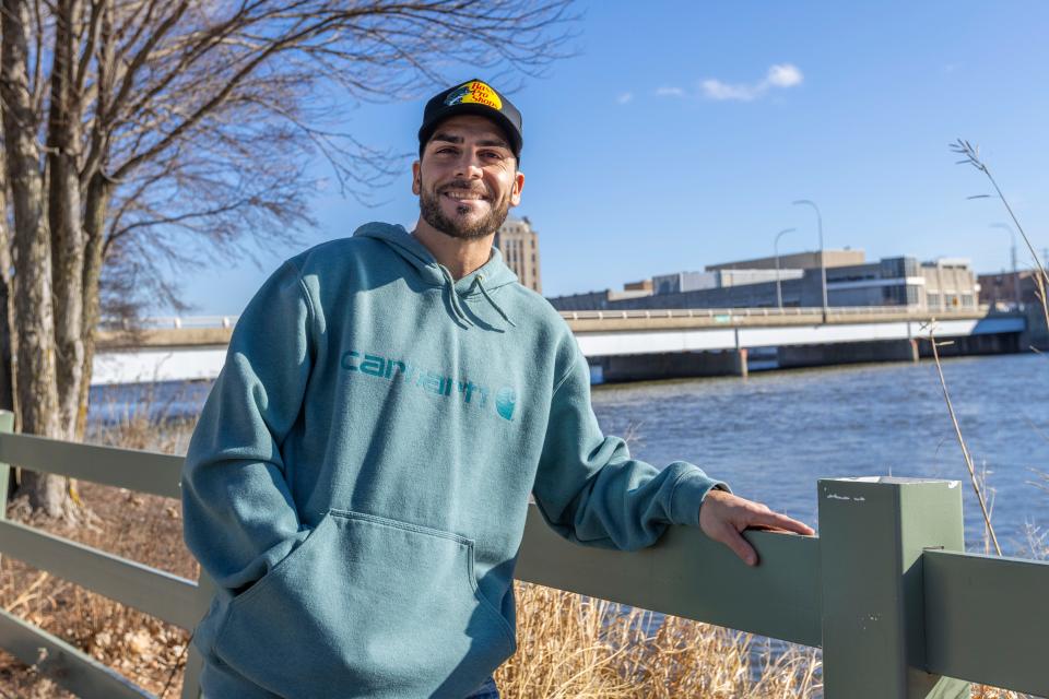 Enzo Fiasche, an addiction recovery coach at a Kalimba Foundation sober-living house in Rockford and a former resident of an Oxford House sober-living house in Rockford, poses for a portrait by the Rock River on Feb. 9, 2024, in Davis Park.