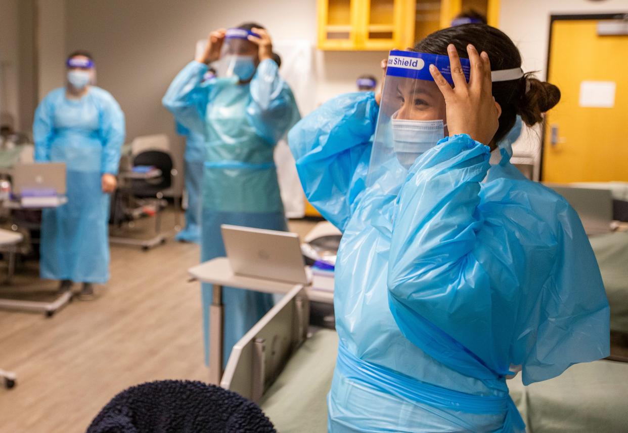 Ivy Tech nursing student Tania Lopez practices wearing PPE during class on Wednesday, Jan. 19, 2022, at Ivy Tech Community College in South Bend. 