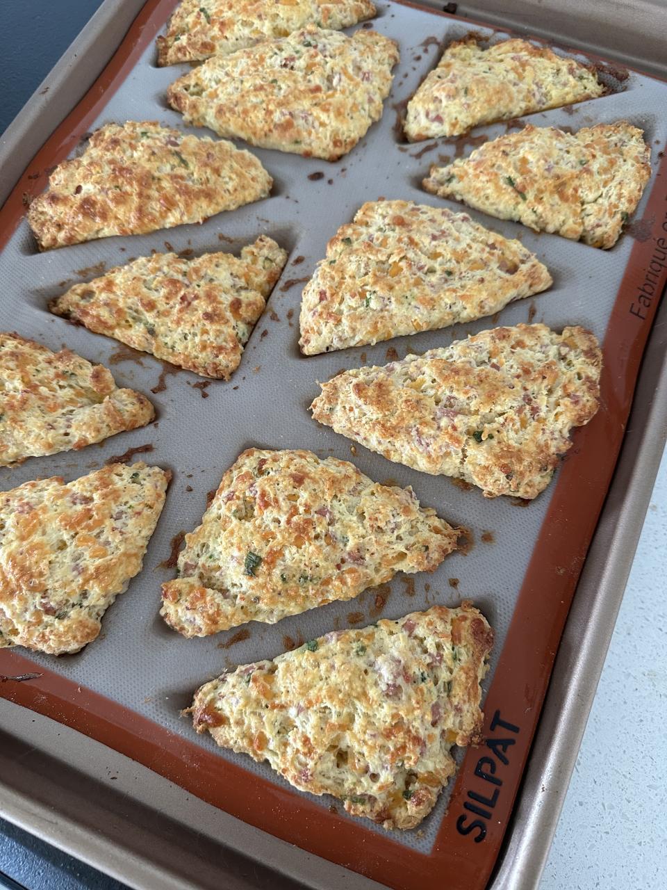 ham and cheese scones in a silicone mold on a sheet pan