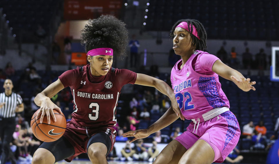 South Carolina guard Destanni Henderson (3) drives toward the basket while defended by Florida guard Ariel Johnson (32) during the second half of an NCAA college basketball game Thursday, Feb. 27, 2020, in Gainesville, Fla. (AP Photo/Gary McCullough)