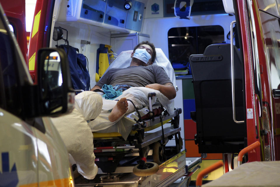 A man lays in an ambulance at the emergency service of the hospital in Papeete, Tahiti island, French Polynesia, Friday Aug.20, 2021. France's worst virus outbreak so far is unfolding 12 times zones away from Paris, devastating Tahiti and the idyllic atolls of French Polynesia. It's France's latest challenge in juggling resources to battle the pandemic in former colonies that stretch around the world (AP Photo/Esther Cuneo)