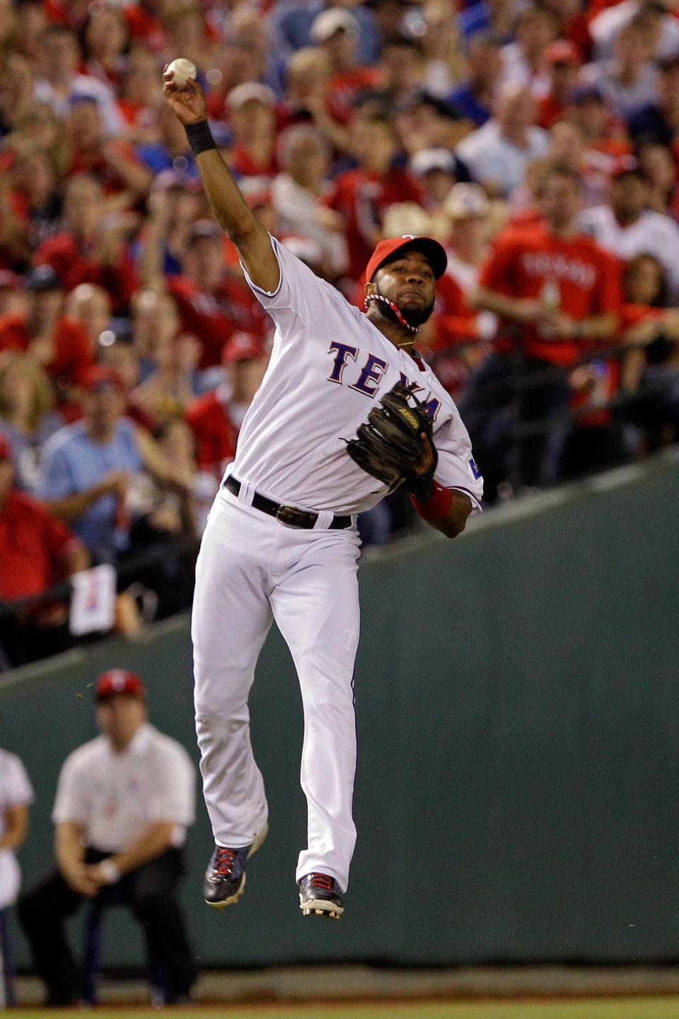 ARLINGTON, TX - OCTOBER 24: Elvis Andrus #1 of the Texas Rangers throws to first base after fielding a hit by Yadier Molina #4 of the St. Louis Cardinals in the eighth inning during Game Five of the MLB World Series at Rangers Ballpark in Arlington on October 24, 2011 in Arlington, Texas. (Photo by Rob Carr/Getty Images)