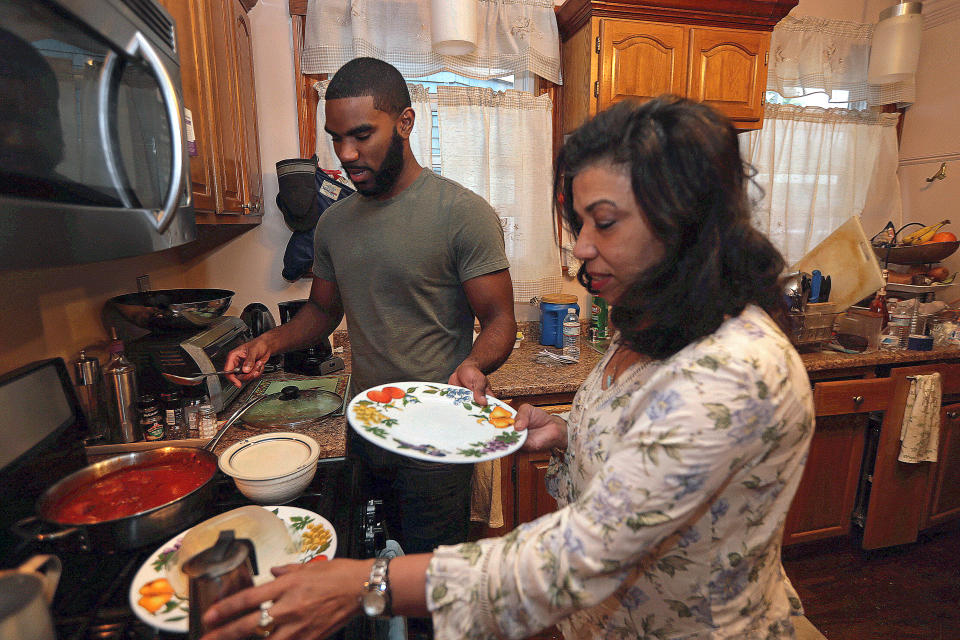 BOSTON, MA - MAY 22: Gabriel Howson, 22, a recent college graduate, is pictured with his mother Monica Beato-Howson at her home in the Dorchester neighborhood of Boston on May 22, 2018. As he opens the next chapter of adulthood, Howson, 22, has landed a $16-an-hour job at Brigham and Womens Hospitals shipping and receiving department, while he looks for a job in real estate investment. He has also moved back to his parents home in Dorchester - part of a new twist on the so-called boomerang trend that has come to define a generation of millennials. But now theyre moving back in greater numbers, and for a different reason than a decade ago, when employers werent hiring because of the recession. Today, younger millennials in Greater Boston are graduating into a robust economy, but a blisteringly hot housing market makes it difficult for many to spread their wings. (Photo by Barry Chin/The Boston Globe via Getty Images)