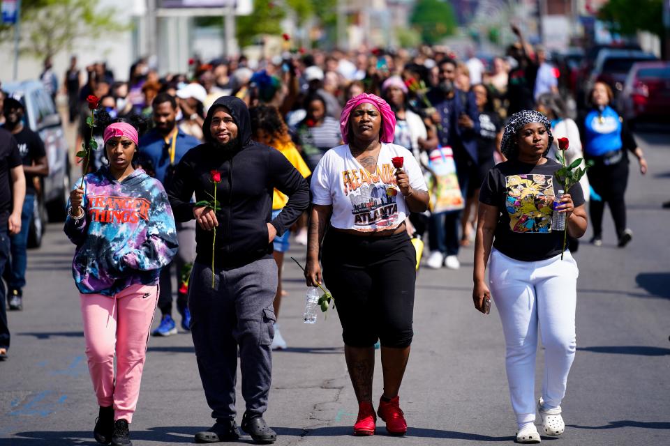 People march to the scene of a shooting at a supermarket in Buffalo, N.Y., on May 15, 2022.  (Matt Rourke / AP)