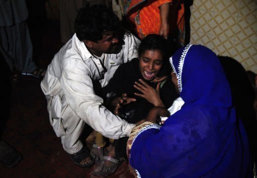 A Pakistani woman mourns the death of relatives after a garment factory was engulfed in a fire in Karachi, on September 11. "Rescue workers have recovered 240 dead bodies, we fear recovery of more bodies as rescue work continues," Karachi city's police chief told AFP