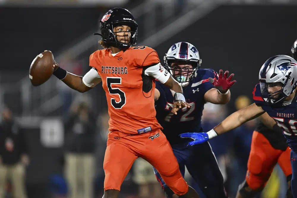 Pittsburg quarterback Jaden Rashada (5) is pressured by Liberty’s Grant Buckey (72) during the second quarter of the 2022 CIF State Football Championship Division 1-A game at Saddleback College in Mission Viejo, Calif., on Dec. 10, 2022. (Jose Carlos Fajardo/Bay Area News Group via AP)