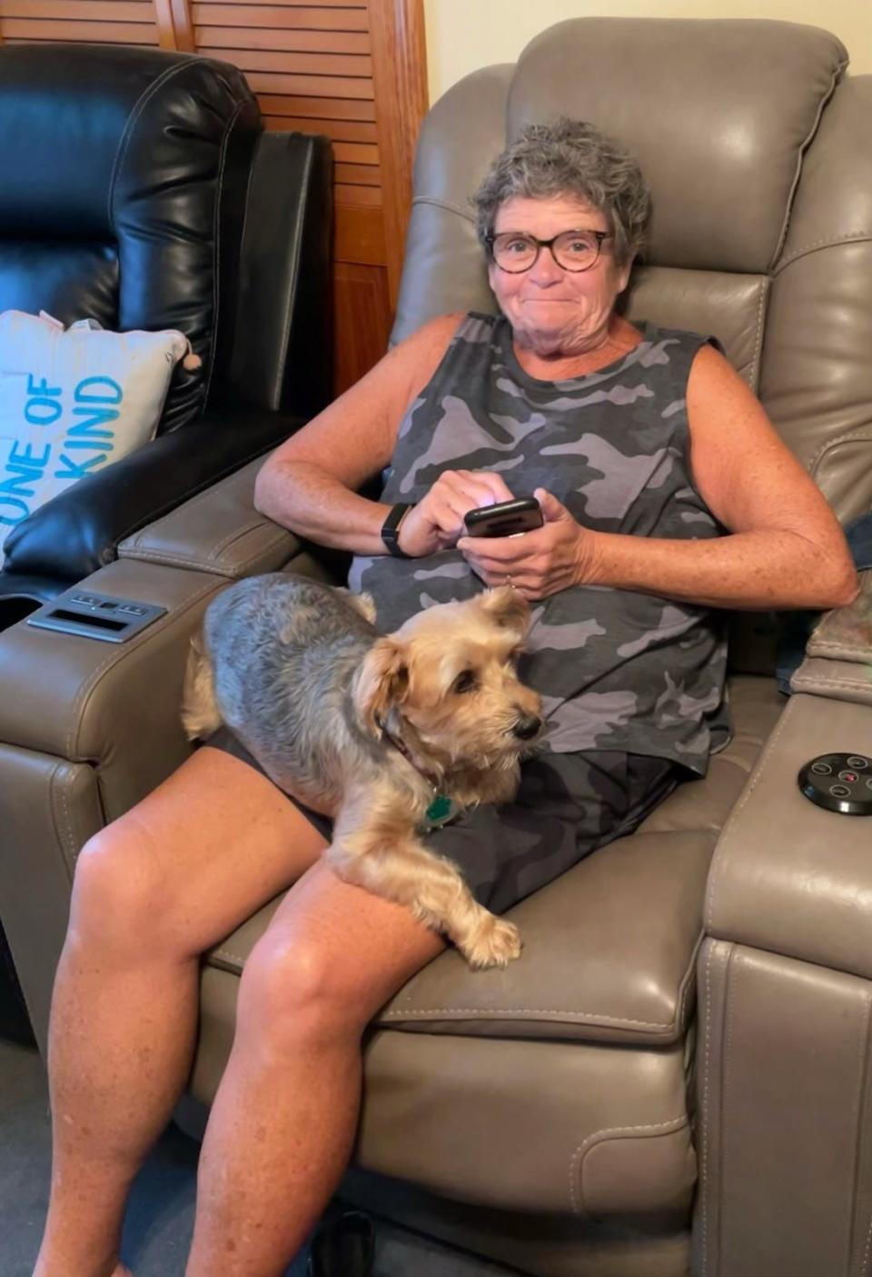 Peggy McGowan sits with dog Brady in her lap. McGowan, of Fall River, was a social worker and, in her retirement, a longtime crossing guard for Fall River Public Schools beloved by students.