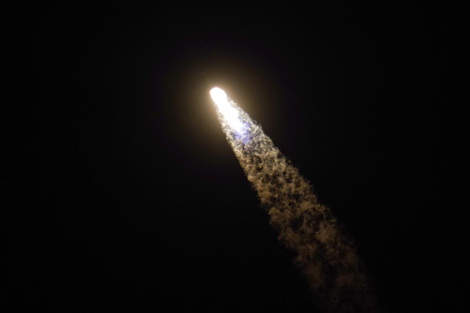 A SpaceX Falcon 9 rocket with the Crew Dragon space capsule leaves a trail of smoke as it lifts off from pad 39A at the Kennedy Space Center in Cape Canaveral, Fla., Friday, April 23, 2021. (AP Photo/John Raoux)