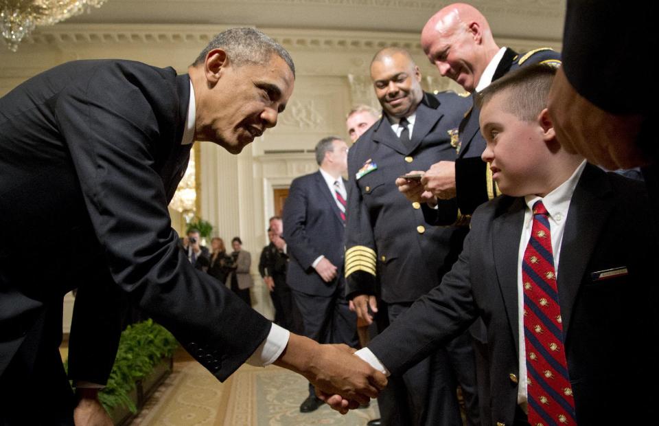 President Barack Obama shakes hands with Brayden Gero, 9, son of Boston Police officer Jarrod Gero, during a ceremony to honor the 2014 National Association of Police Organizations (NAPO) TOP COPS in East Room of the White House in Washington, Monday, May 12, 2014. (AP Photo)