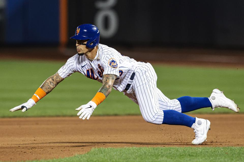 New York Mets shortstop Javier Baez slides to second base with a double against the San Francisco Giants at Citi Field, Aug. 26, 2021.
