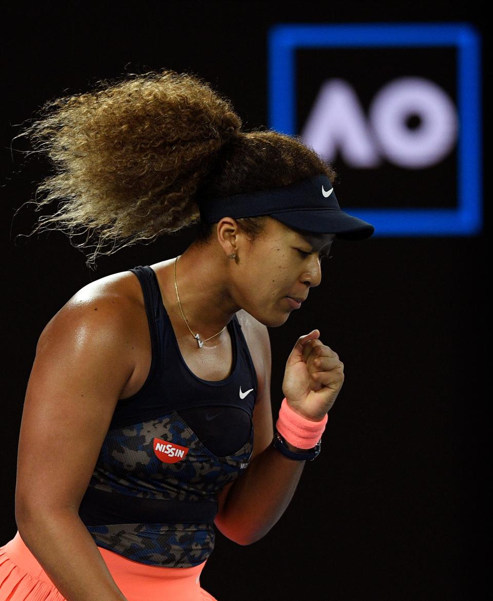 Naomi Osaka reacts after winning a point against Jennifer Brady on the way to her fourth career Grand Slam title.