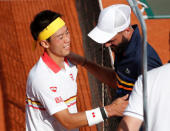 Tennis - French Open - Roland Garros, Paris, France - May 30, 2018 Japan's Kei Nishikori with France's Benoit Paire after winning their second round match REUTERS/Pascal Rossignol