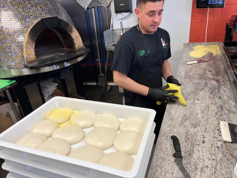 Vincenzo Buonanotte, Tutti Da Gio pizza maker and son of the restaurant's owner/chef, prepares to make pizza with housemade dough in a wood-burning oven Feb. 27, 2024