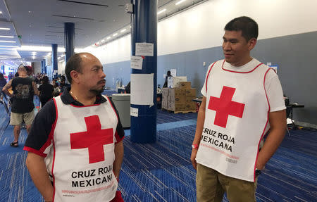 Marco Franco (L), deputy director of Mexican Red Cross disaster relief, talks with Gustavo Santillan part of a group of 33 Mexican Red Cross volunteers helping victims of Hurricane Harvey, at the George R. Brown convention center in Houston, Texas, U.S. on September 4, 2017. Picture taken on September 4, 2017. REUTERS/Ruthy Munoz