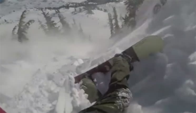 The snow cover breaks away underneath Tom Oye and starts dragging the snowboarder in an avalanche. From Facebook.