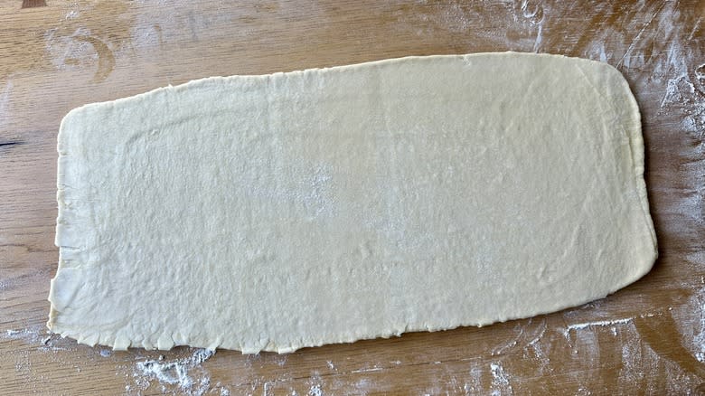 rolled dough on floured counter
