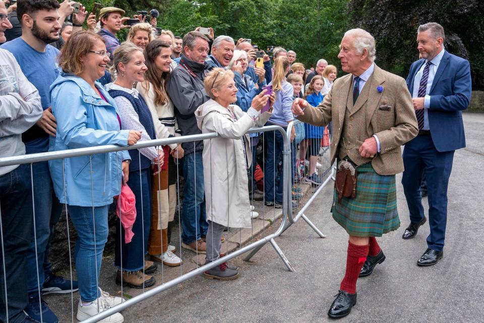 King Charles, right, approached the crowd of royal enthusiasts at the Balmoral Castle ceremony Monday.